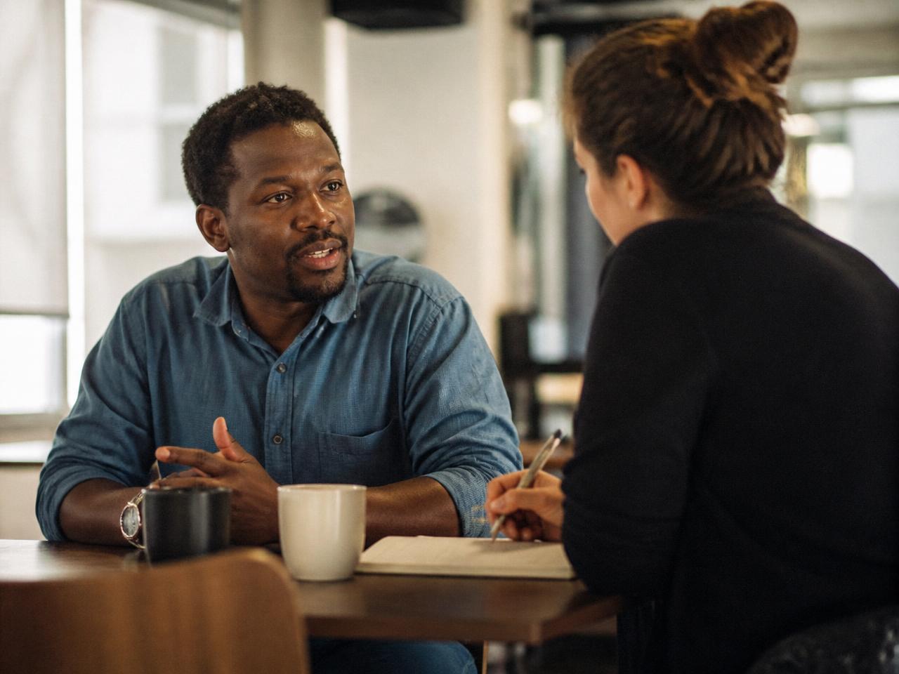 A business owner and a strategist talking through a plan together in a bright office
